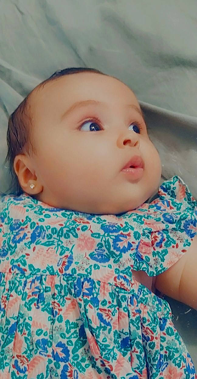 Adriana participe au concours pour gagner de l'argent avec cette photo : azure, baby, baby_toddler_clothing, cheek, collar, dress, eye, eyebrow, eyelash, hairstyle, iris, lip, neck, nose, organ, outerwear, person, pink, skin, sleeve