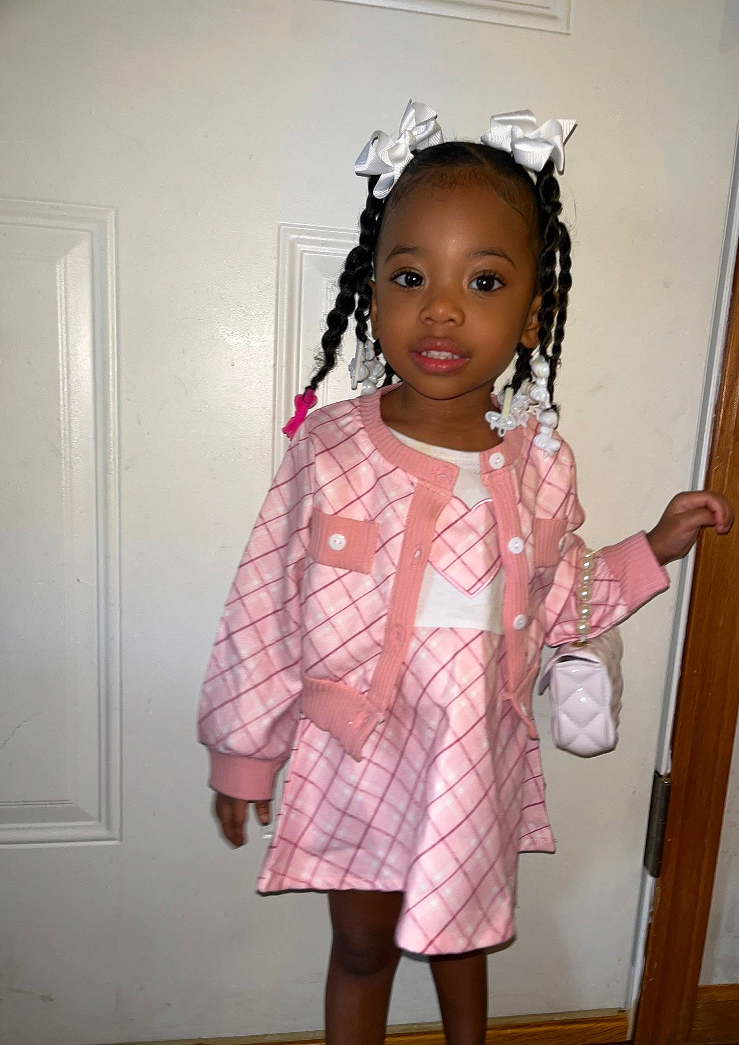 Ivy is registered to the contest to win money with this photo: baby_toddler_clothing, cheek, child, day_dress, door, embellishment, facial_expression, fashion_design, formal_wear, hair, hairstyle, lip, magenta, one_piece_garment, pattern, person, pink, skin, sleeve, standing