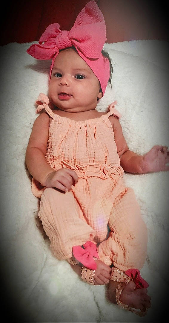 Katalina is registered to the contest to win money with this photo: baby, baby_products, baby_toddler_clothing, bonnet, cheek, child, child_model, costume, costume_accessory, costume_hat, day_dress, embellishment, hair_accessory, headband, headwear, peach, person, pink, skin, toddler