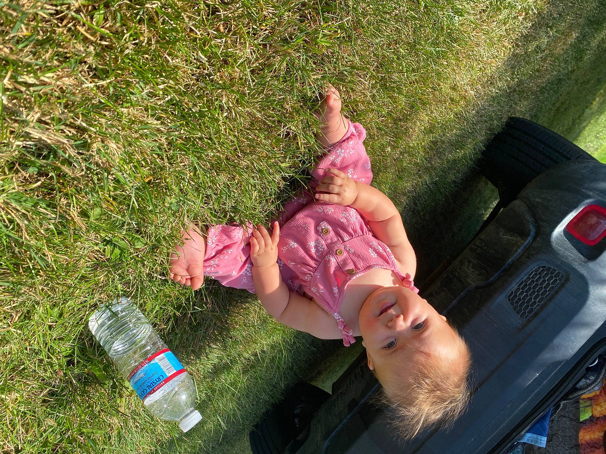 Nevaeha is registered to the contest to win money with this photo: bumper, child, fun, grass, grass_family, happy, human_leg, lawn, leisure, motor_vehicle, people_in_nature, person, plant, plastic_bottle, recreation, sitting, smile, toddler, tree, vehicle_door