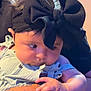 Melonie Me-Lon-e joined the competition — help win amazing prizes! baby, child, black_bow, headband, tattoo, arm, cute, infant, clothing, person, portrait, skin, hand, face, indoors, holding, curious, sitting, young, closeup