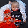 Kristopher is registered to the contest to win money with this photo: baby, infant, child, sleeping, crying, dress, headband, red_clothing, black_clothing, blanket, fluffy, valentines_day, cute, two_children, lying_down, indoor, portrait, celebration, holiday, toddler