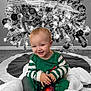 Kristopher joined the competition — help win amazing prizes! baby, child, christmas_tree, ornament, holiday, smiling, pajamas, blanket, basket, carpet, decorations, festive, indoor, celebration, joyful, cute, holiday_lights, red_ornament, green_clothing, smile