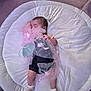 Aislynn is registered to the contest to win money with this photo: baby, sleeping, crown, veil, pink, pearls, flower, cushion, white, soft, infant, cute, child, sock, striped_socks, resting, indoor, fabric, blanket, peaceful