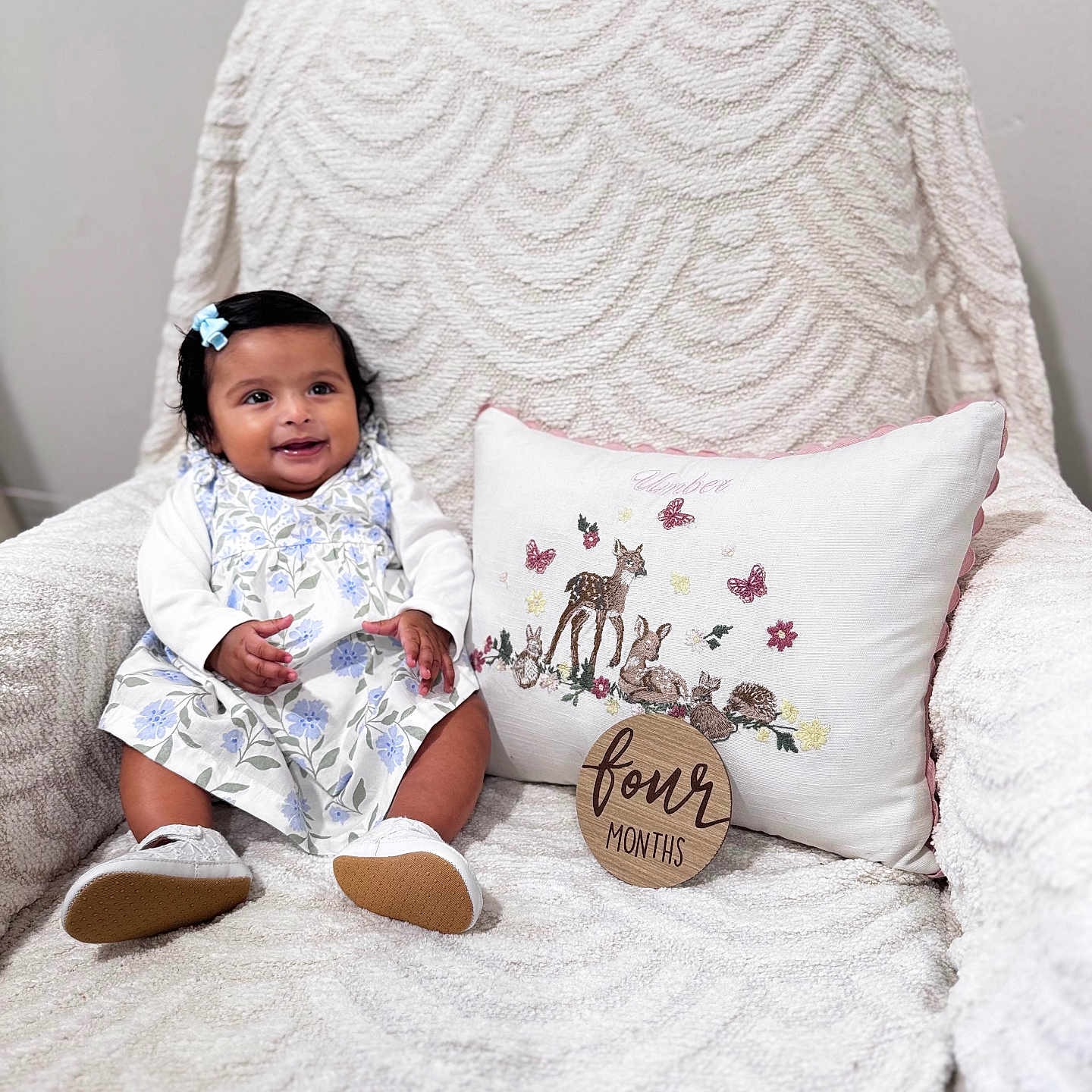 Umber is registered to the contest to win money with this photo: armchair, baby, bow, butterflies, child, dress, embroidery, floral_pattern, four_months, hair_accessory, happy, indoor, infant, milestone_sign, pillow, sitting, smiling, textured_fabric, white_shoes, woodland_animals