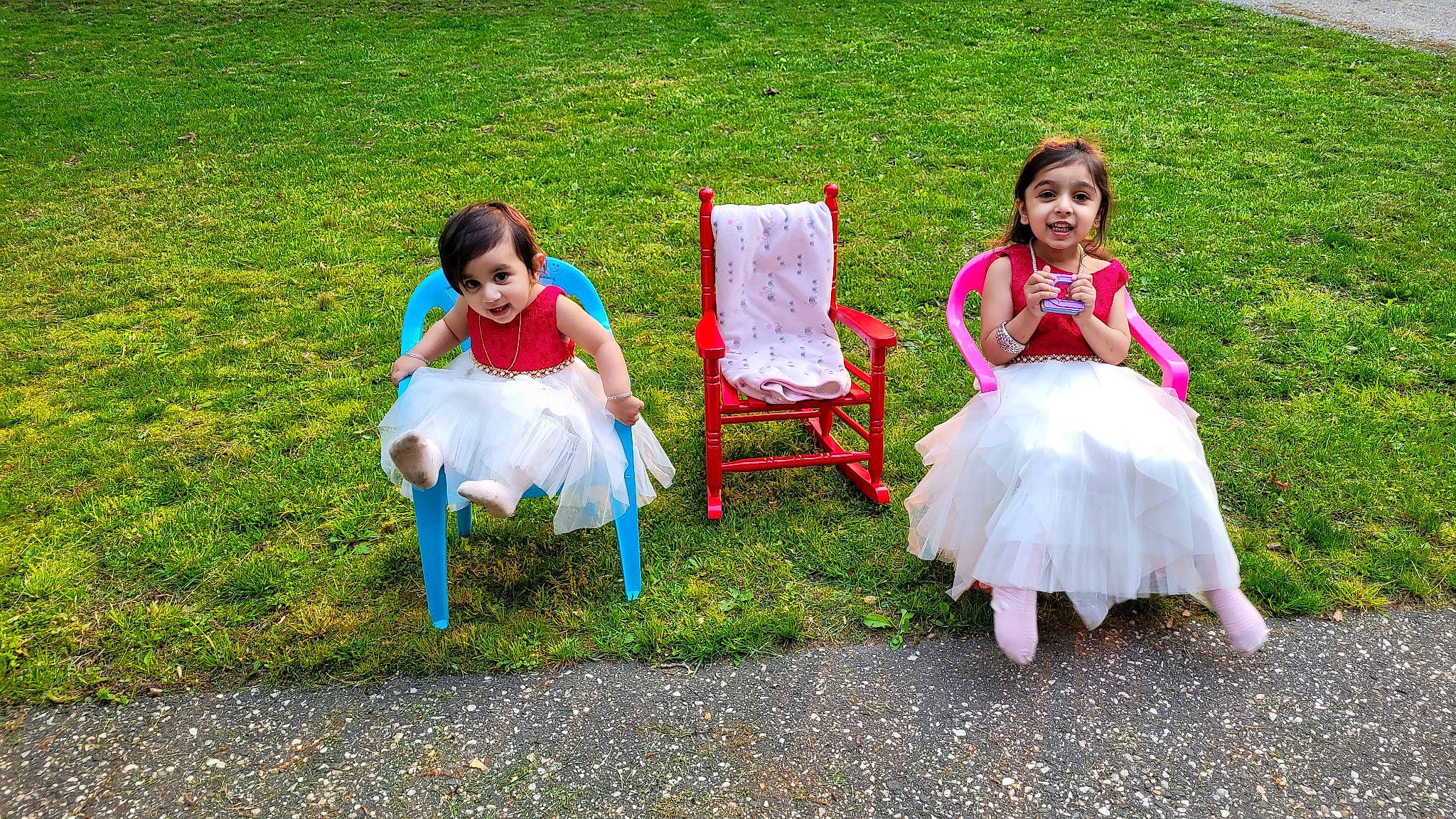Aryaa is registered to the contest to win money with this photo: chair, child, dress, event, fun, grass, grass_family, happy, joy, lawn, leisure, mammal, outdoor_furniture, people_in_nature, person, plant, recreation, shoe, sitting, summer