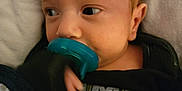 Donavon is registered to the contest to win money with this photo: baby, blanket, child, closeup, clothing, comfort, cute, expression, face, hand, indoors, infant, newborn, pacifier, portrait, resting, sleepwear, soft_fabric, toddler, young_child