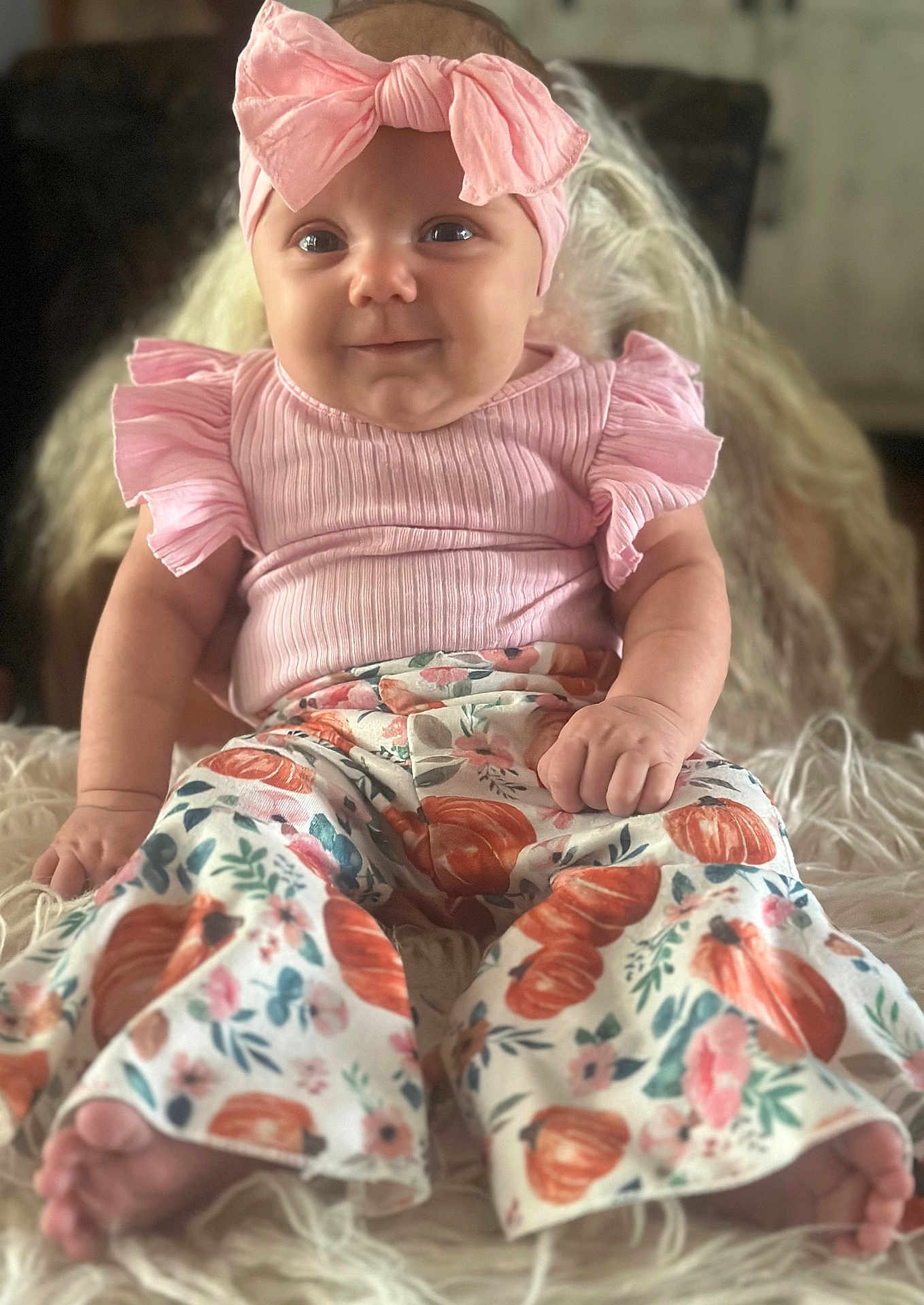 Mazeleigh joined the competition — help win amazing prizes! baby, pink_bow, headband, smile, pink_top, ruffled_sleeves, floral_pants, pumpkin_pattern, barefoot, sitting, fluffy_surface, cute, infant, portrait, indoor, soft_lighting, happy, child, closeup, adorable