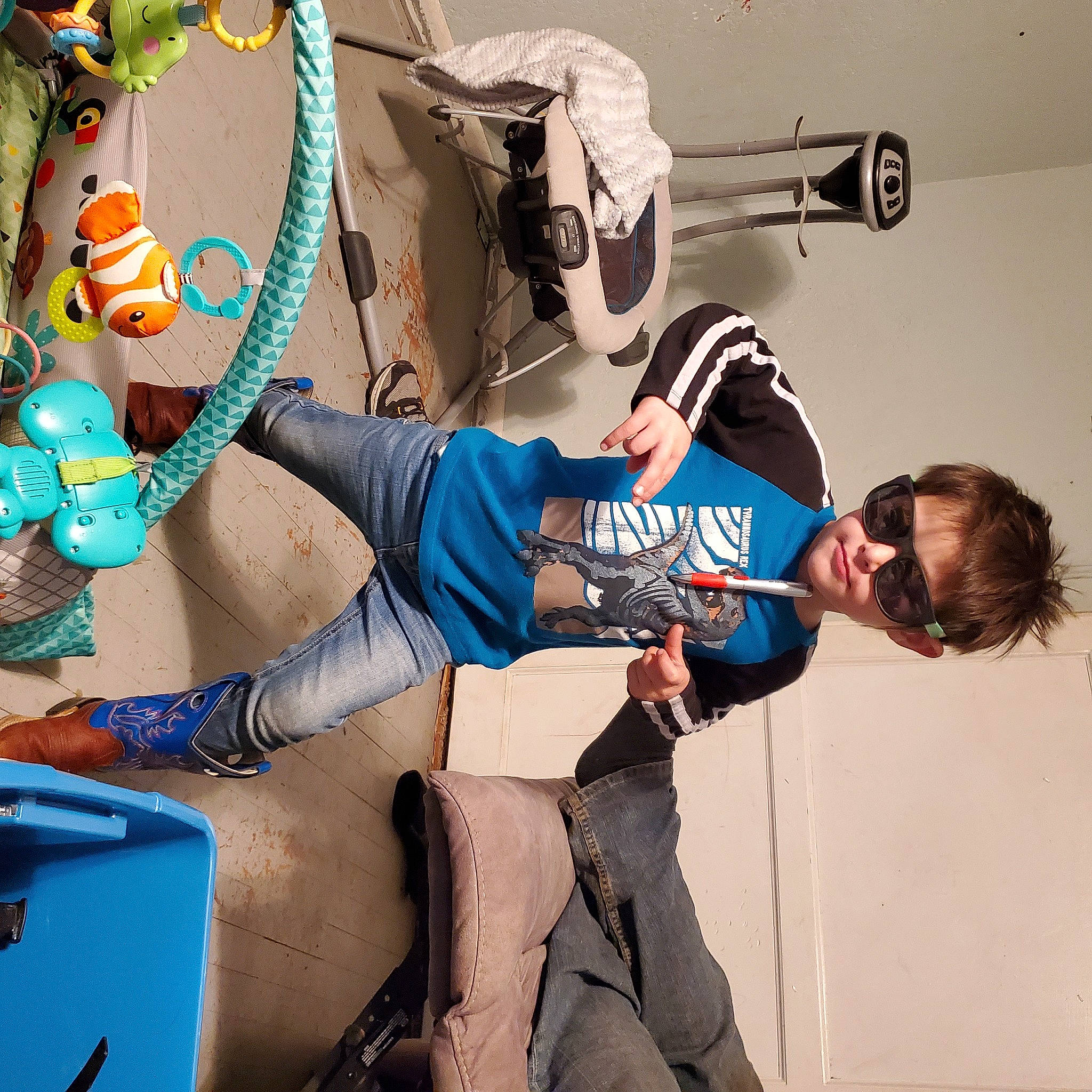 Maverick is registered to the contest to win money with this photo: bag, boot, cool, elbow, electric_blue, fictional_character, fun, human_leg, joint, knee, luggage_and_bags, person, room, shoe, shorts, sneakers, sportswear, t_shirt, thigh