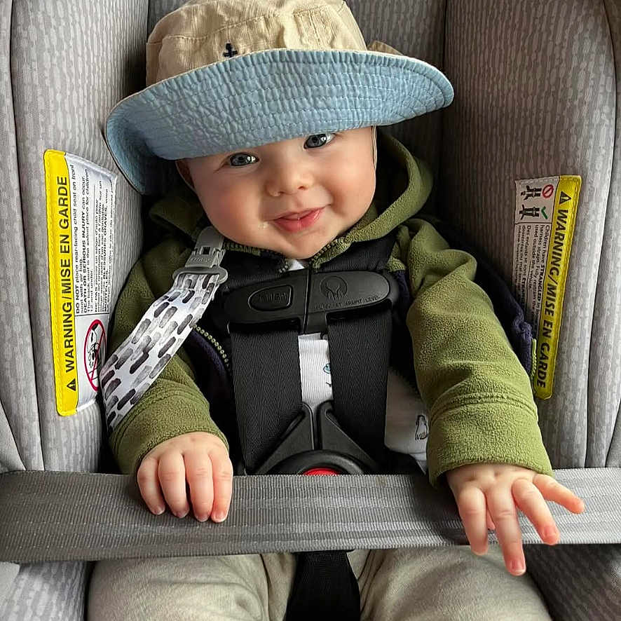 Levi is registered to the contest to win money with this photo: accessories, baby, belt, bodypart, car, car_interior, carseat, clothing, cushion, face, finger, hat, head, homedecor, person, photography, portrait, sleeping, transportation, vehicle
