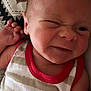 baby, infant, face, expression, funny_face, striped_clothing, tank_top, red_trim, hand, skin, newborn, lying_down, blanket, pattern, close_up, cute, child, person, indoors, portrait