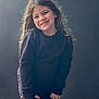 Sophie is registered to the contest to win money with this photo: child, smiling, portrait, long_hair, black_clothing, happy, standing, hands, bandage, casual, studio, young, person, cute, light, indoor, fashion, playful, face, expression