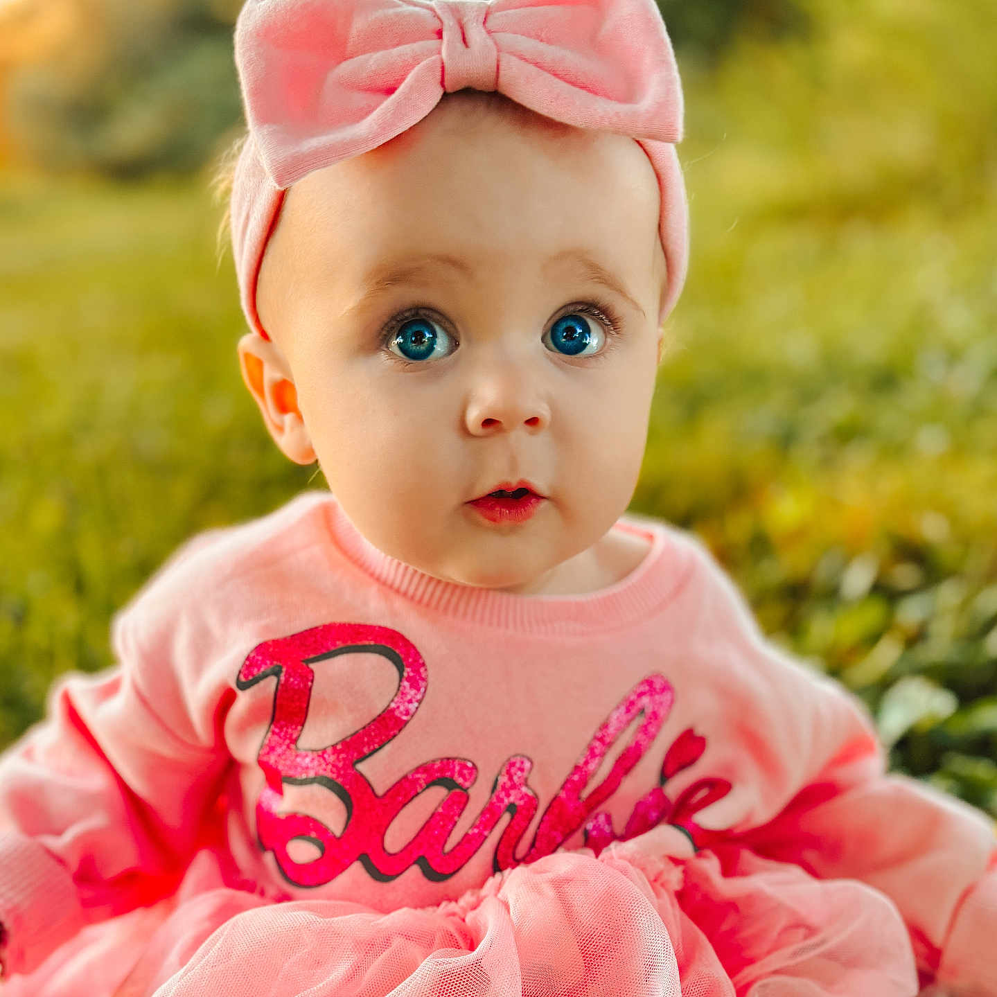 Nellie is registered to the contest to win money with this photo: accessories, baby, bonnet, bowtie, clothing, doll, dress, face, formalwear, happy, hat, head, headband, person, photography, portrait, sitting, smile, tie, toy