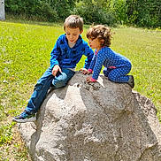 Bella joined the competition — help win amazing prizes! child, children, rock, grass, outdoor, nature, trees, sunlight, field, play, clothing, pajamas, jacket, jeans, shoes, curly_hair, short_hair, daylight, fun, adventure