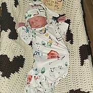 Declan joined the competition — help win amazing prizes! baby, bed, blanket, clothing, couch, cradle, crib, cushion, face, furniture, hat, head, homedecor, infantbed, newborn, person, photography, portrait, quilt, sleeping