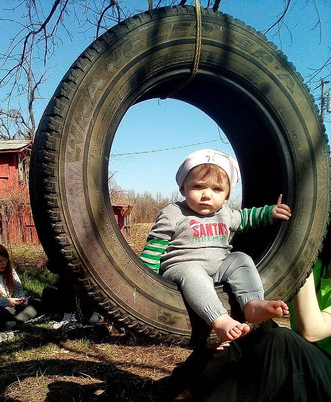 Madilyn is registered to the contest to win money with this photo: auto_part, automotive_tire, automotive_wheel_system, circle, city, flash_photography, fun, grass, happy, leisure, people_in_nature, person, plant, playground, recreation, sky, synthetic_rubber, tire, toddler, tread