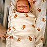 baby, newborn, swaddled, blanket, elephant_pattern, headband, bow, sleeping, infant, cute, cozy, bed, soft, wrapped, child, portrait, indoor, peaceful, small, person
