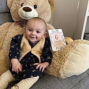Emmy participe au concours pour gagner de l'argent avec cette photo : baby, teddy_bear, plush_toy, milestone_card, smiling, child, sitting, cozy_clothing, indoor, furniture, couch, cute, portrait, soft_texture, celebration, milestone, happy, person, infant, warm