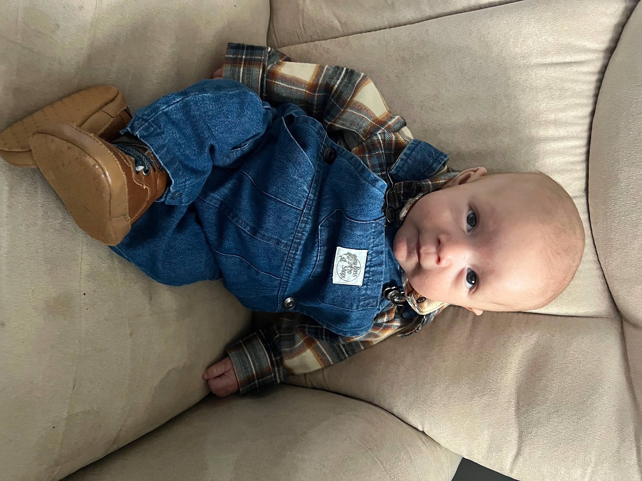 Emmett is registered to the contest to win money with this photo: arm, baby, baby_toddler_clothing, child, comfort, couch, eye, finger, hand, human_body, iris, leg, pattern, person, room, sitting, skin, sleeve, thigh, toddler
