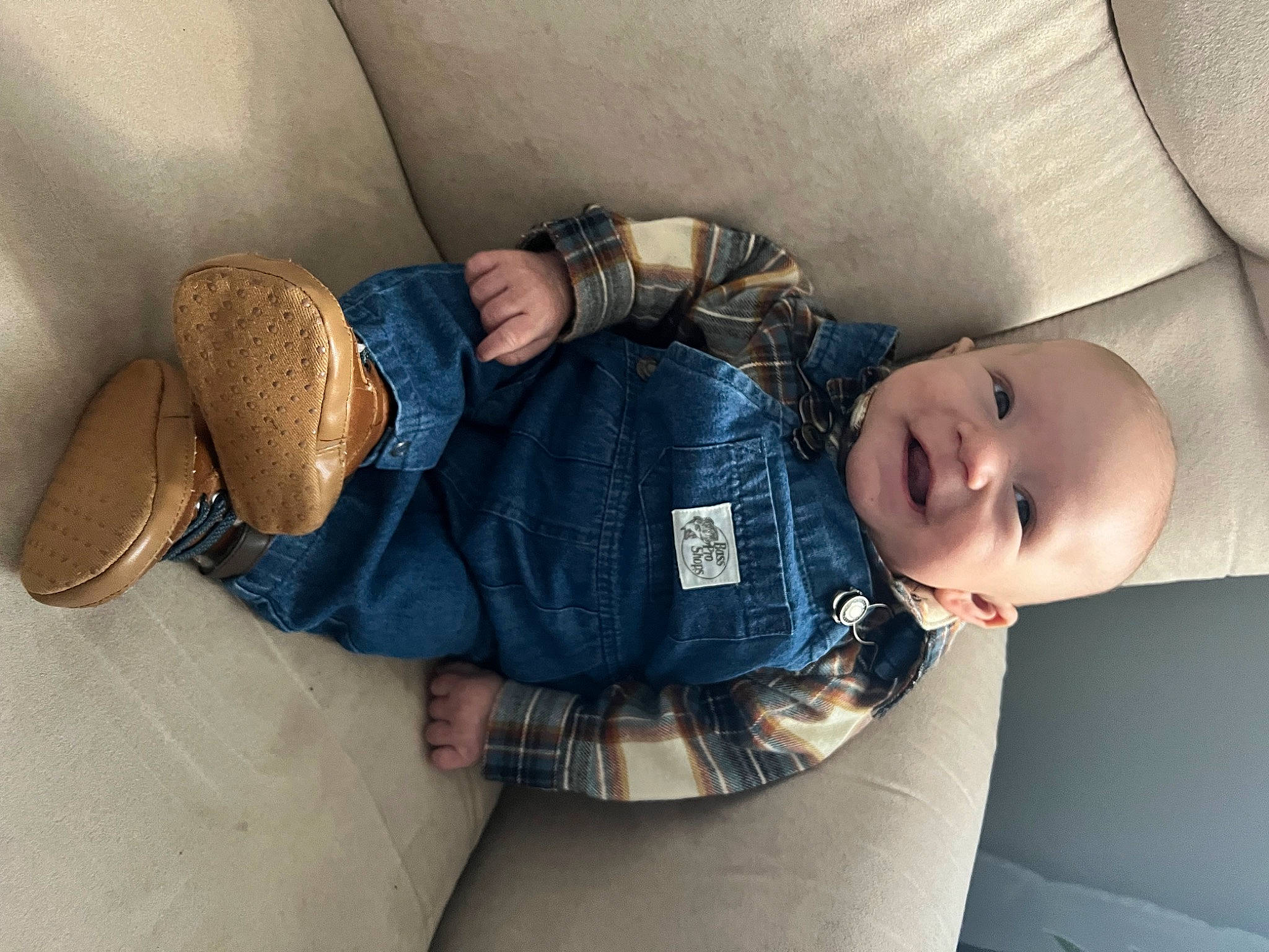 Emmett is registered to the contest to win money with this photo: arm, baby, baby_toddler_clothing, child, comfort, denim, fashion_accessory, finger, glasses, hand, hat, headgear, human_leg, leg, person, sitting, smile, thigh, toddler, wood