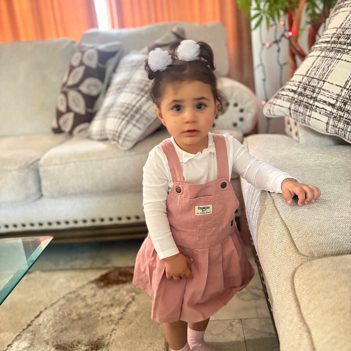 Amaly joined the competition — help win amazing prizes! carpet, casual, child, couch, curious, floor, furniture, girl, hair_ties, home, indoors, living_room, pillows, pink_dress, plant, portrait, socks, standing, toddler, white_shirt