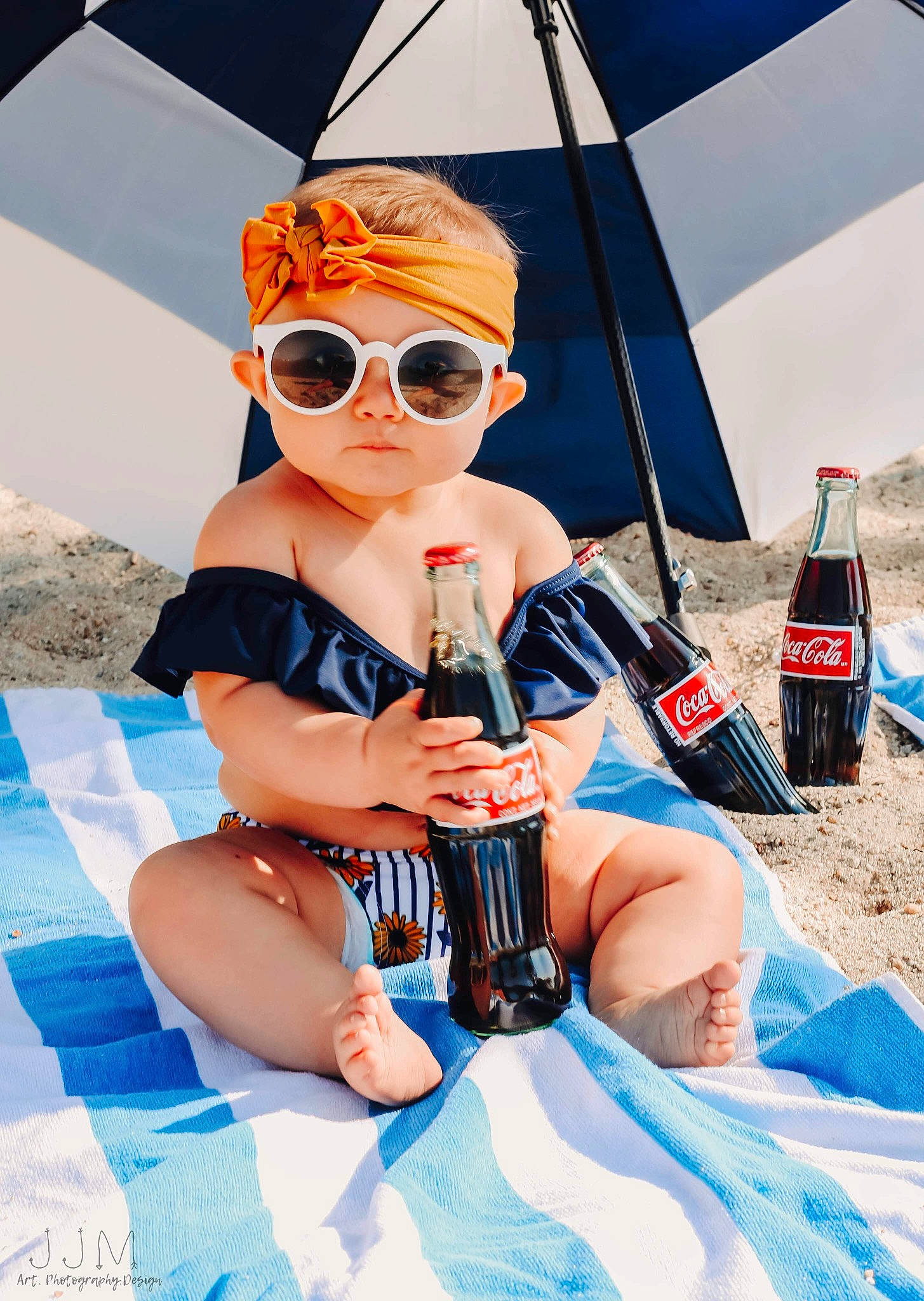 Kayce is registered to the contest to win money with this photo: aqua, bottle, carbonated_soft_drinks, drink, drinkware, eyewear, fedora, finger, glasses, goggles, hand, hat, headwear, linens, nail, person, plastic_bottle, sun_hat, sunglasses, tent