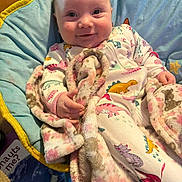 Opal is registered to the contest to win money with this photo: baby, blanket, blue, chair, child, cozy, cushion, cute, dinosaur_print, hand, happy, indoor, infant, onesie, person, pink, portrait, smile, soft_texture, yellow