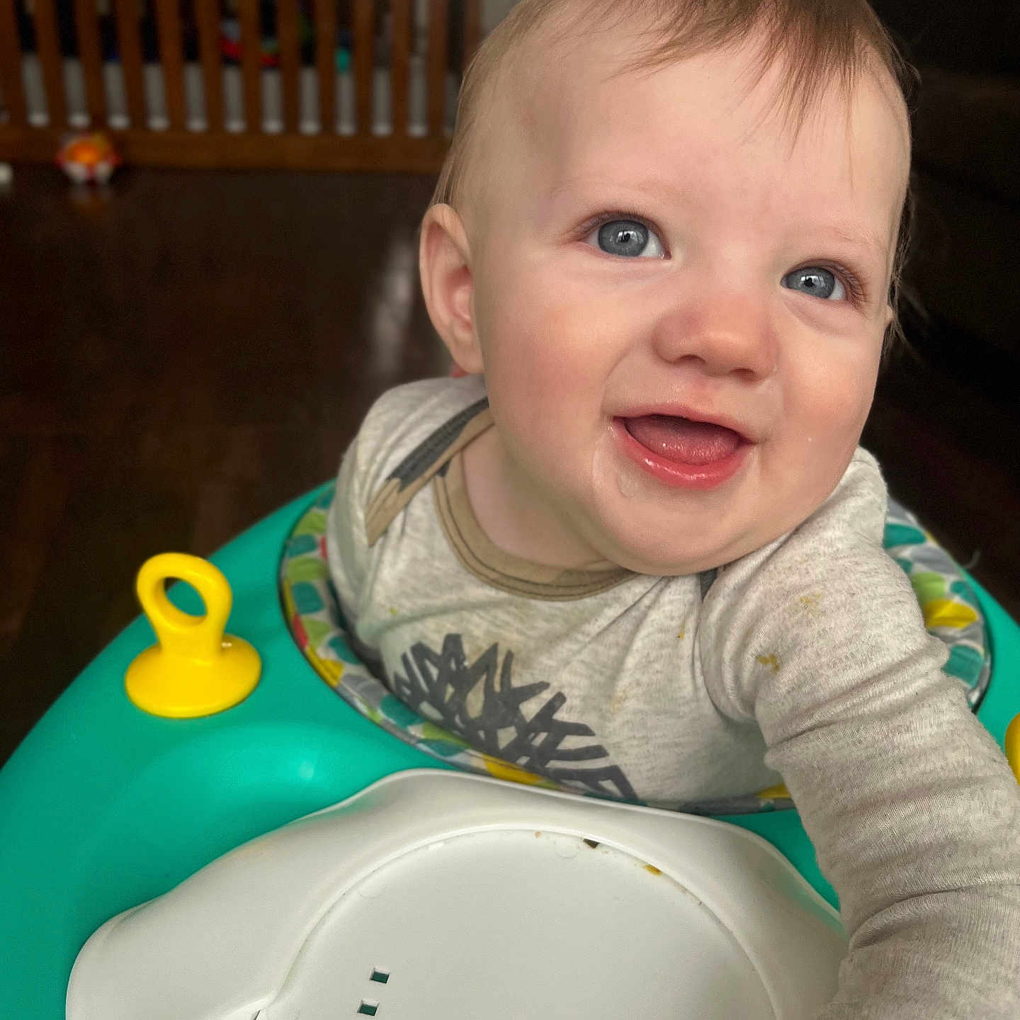 Liam joined the competition — help win amazing prizes! baby, blue_eyes, blurred_background, child, clothing, face, floor, furniture, hair, hand, happy, home, indoor, infant, mouth, person, skin, smile, toy, walker