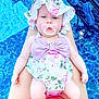baby, infant, swimsuit, sunhat, pacifier, pool, water, legs, summer, outdoor, child, cute, floral_pattern, pink, lavender, relaxing, skin, person, vacation, sitting