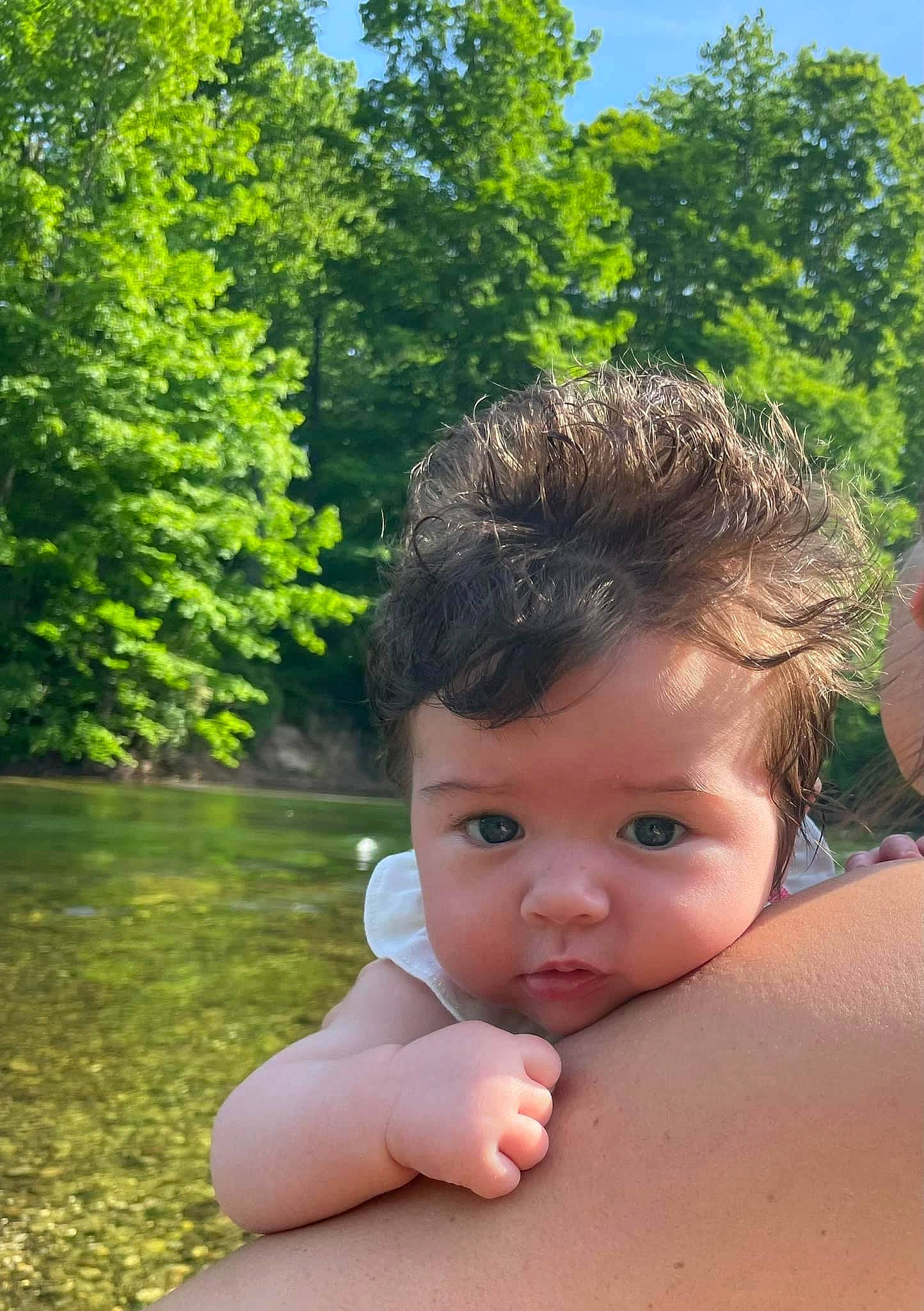 Rylie is registered to the contest to win money with this photo: baby, chest, chin, eye, finger, fun, gesture, grass, hand, happy, leisure, lip, people_in_nature, person, plant, skin, sky, sunlight, toddler, tree