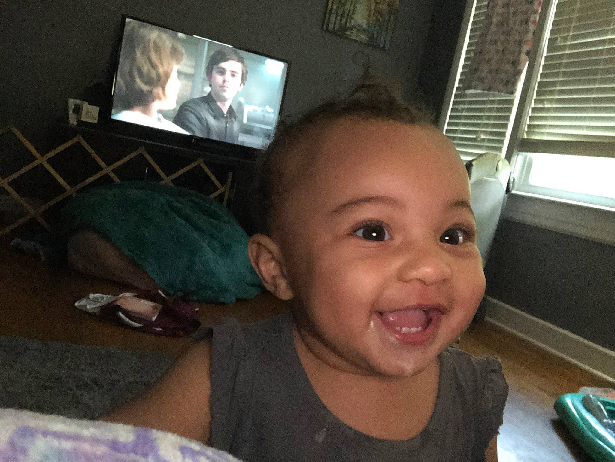 Klover is registered to the contest to win money with this photo: cheek, child, chin, fun, gadget, happy, head, iris, joy, mouth, nose, person, picture_frame, room, smile, t_shirt, television, television_set, thumb, toddler