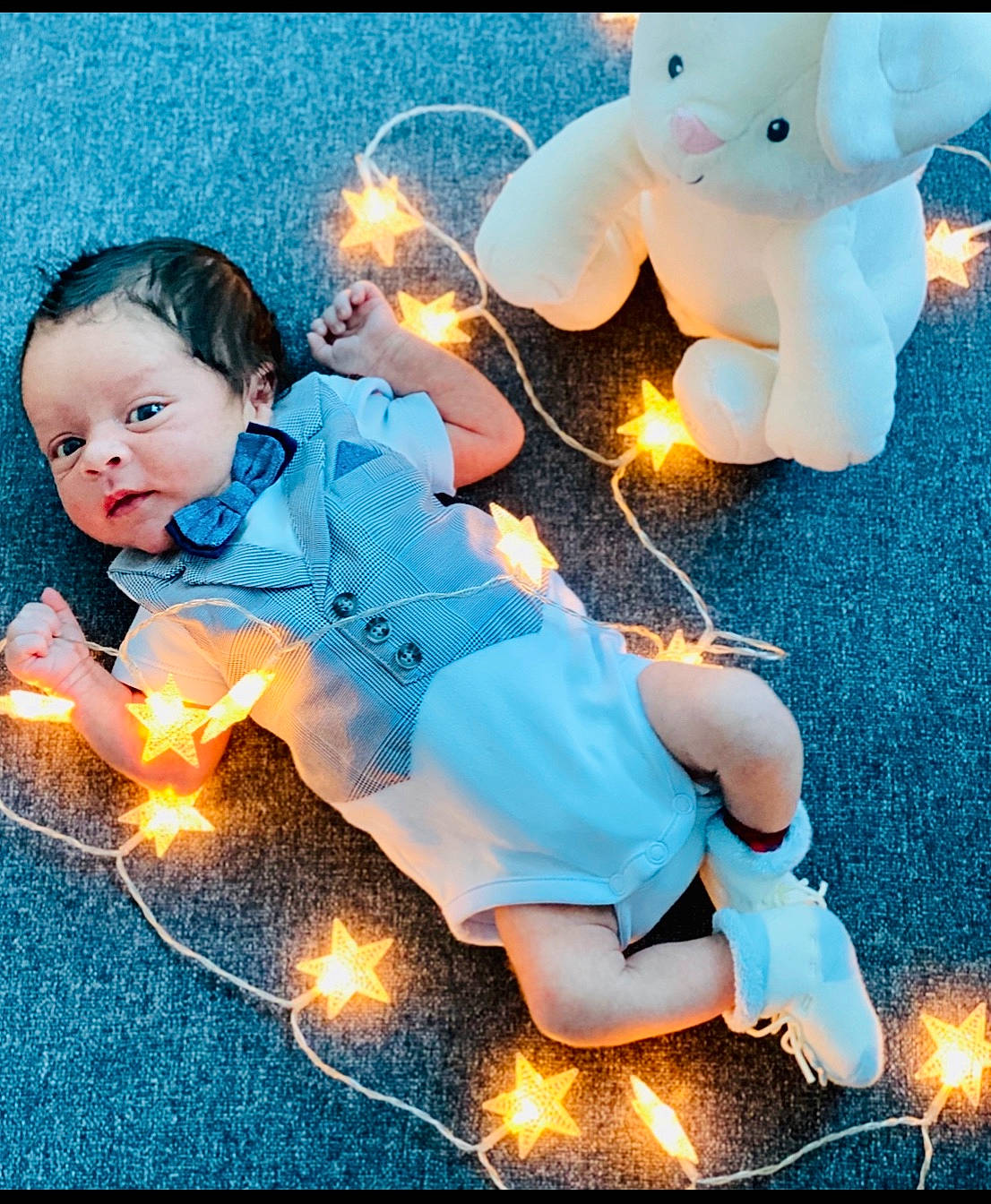 Francisco is registered to the contest to win money with this photo: child, christmas, christmas_decoration, christmas_eve, christmas_lights, fictional_character, fun, happy, interior_design, person, sky, toddler
