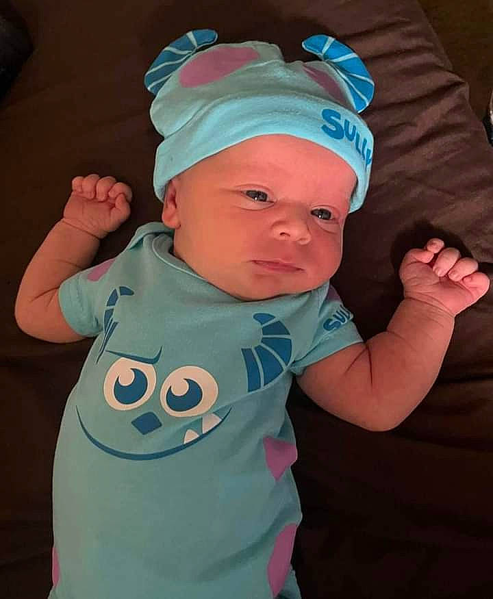 Jericho is registered to the contest to win money with this photo: baby, baby_toddler_clothing, baseball_cap, cap, cheek, cool, electric_blue, facial_expression, finger, fun, gesture, happy, headwear, person, personal_protective_equipment, pink, product, sleeve, t_shirt, textile