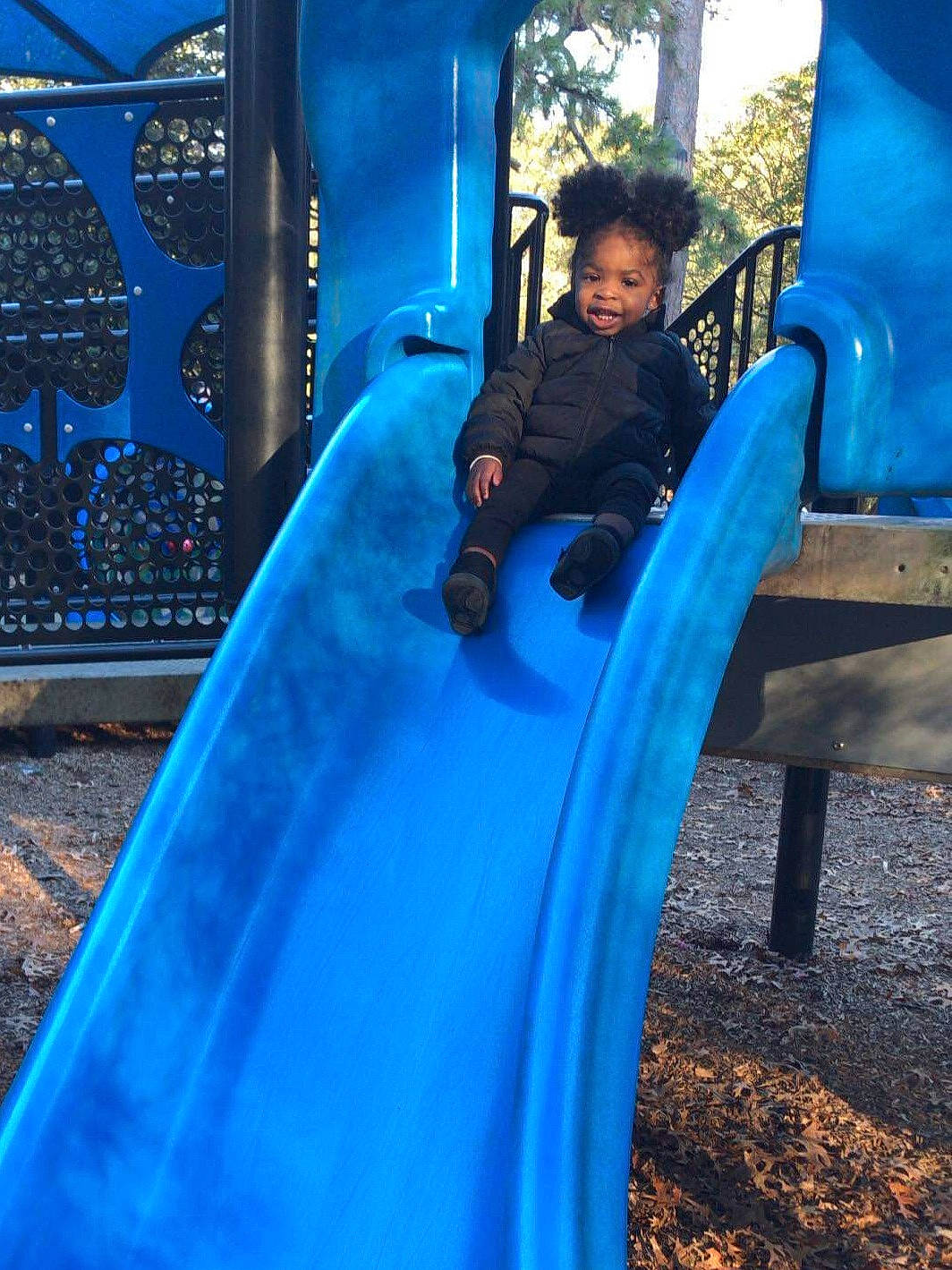 Judea is registered to the contest to win money with this photo: blue, child, chute, city, electric_blue, fun, human_settlement, leisure, outdoor_play_equipment, park, person, play, playground, playground_slide, public_space, recreation, smile, vacation, water, world