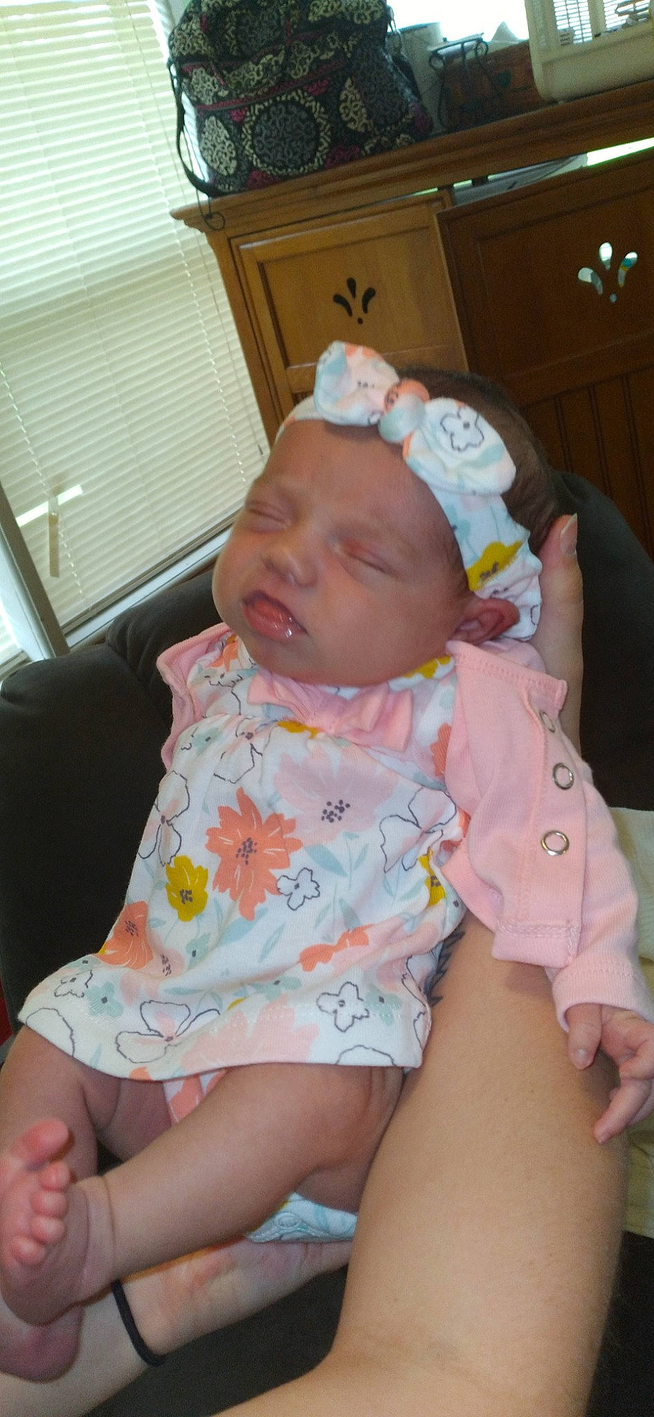 Hazel is registered to the contest to win money with this photo: baby, baby_toddler_clothing, chair, cheek, chin, comfort, eye, facial_expression, finger, fun, headwear, iris, lap, lip, mouth, nose, person, pink, product, skin