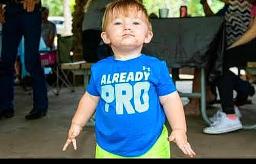 Ace is registered to the contest to win money with this photo: active_shirt, chair, child, electric_blue, event, fun, happy, leisure, person, recreation, sitting, sleeve, standing, t_shirt, toddler, top