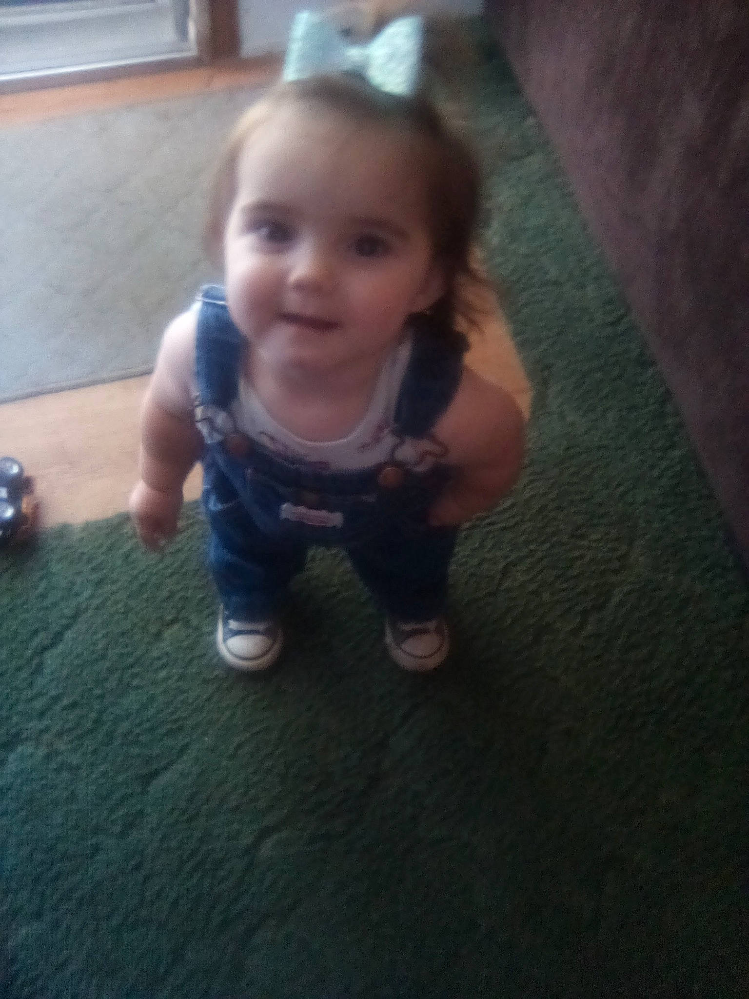 Hazel is registered to the contest to win money with this photo: baby, baby_toddler_clothing, cheek, child, eye, face, flooring, foot, fun, happy, hardwood, human_leg, iris, mouth, nose, person, skin, smile, thumb, toddler