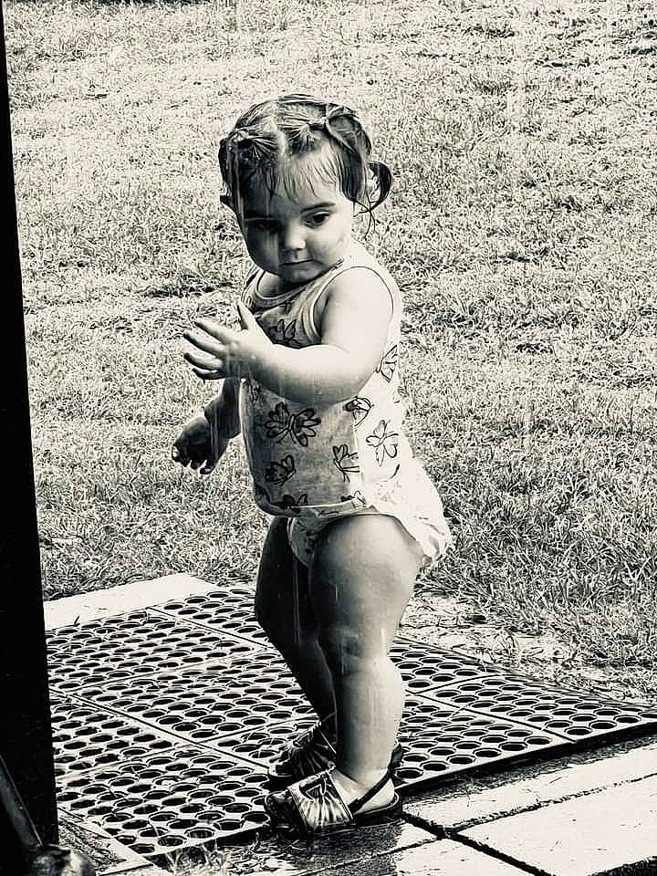 Hazel is registered to the contest to win money with this photo: black_and_white, dress, eye, flash_photography, flooring, foot, hand, happy, human_body, human_leg, knee, monochrome, monochrome_photography, people_in_nature, person, shoulder, standing, style, thigh, toddler