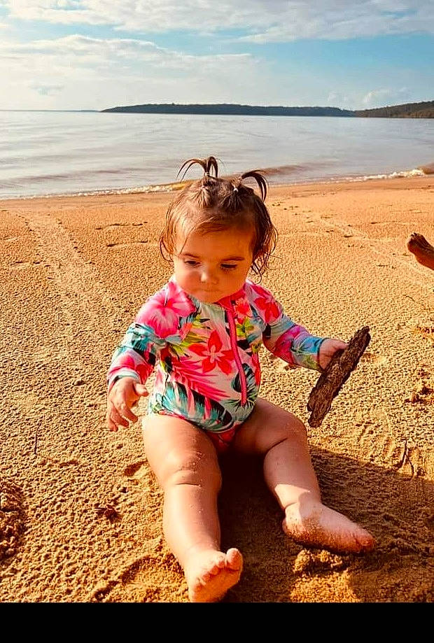 Hazel Grace is registered to the contest to win money with this photo: beach, cloud, coastal_and_oceanic_landforms, fun, grass, happy, knee, landscape, leg, leisure, people_in_nature, people_on_beach, person, photograph, sand, sky, sunlight, thigh, toddler, travel