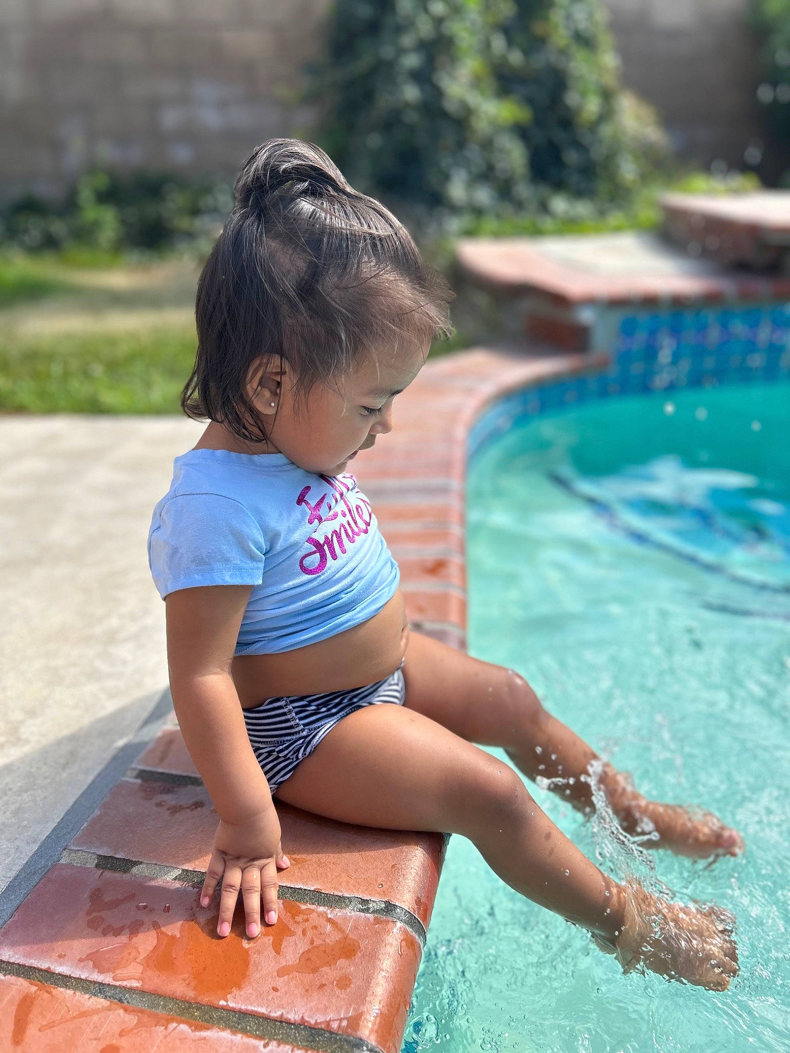 Olyvia is registered to the contest to win money with this photo: azure, barefoot, bathing, beauty, body_of_water, fun, grass, happy, human_leg, leg, leisure, person, photograph, plant, recreation, summer, swimming_pool, thigh, toddler, tree
