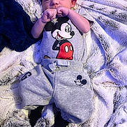 Kashtyn joined the competition — help win amazing prizes! baby, infant, child, portrait, lying_down, blanket, fuzzy_blanket, pajamas, mickey_mouse, beanie, black_hat, gray_clothing, sleeping, awake, hands, face, indoor, cozy, close_up, cute