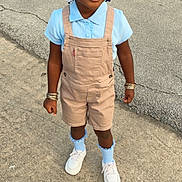 Aartaviah joined the competition — help win amazing prizes! child, smiling, portrait, outdoor, standing, pavement, street, overalls, shirt, braids, hair_ribbons, socks, sneakers, bracelets, fashion, daylight, full_body, person, happy, casual_clothing