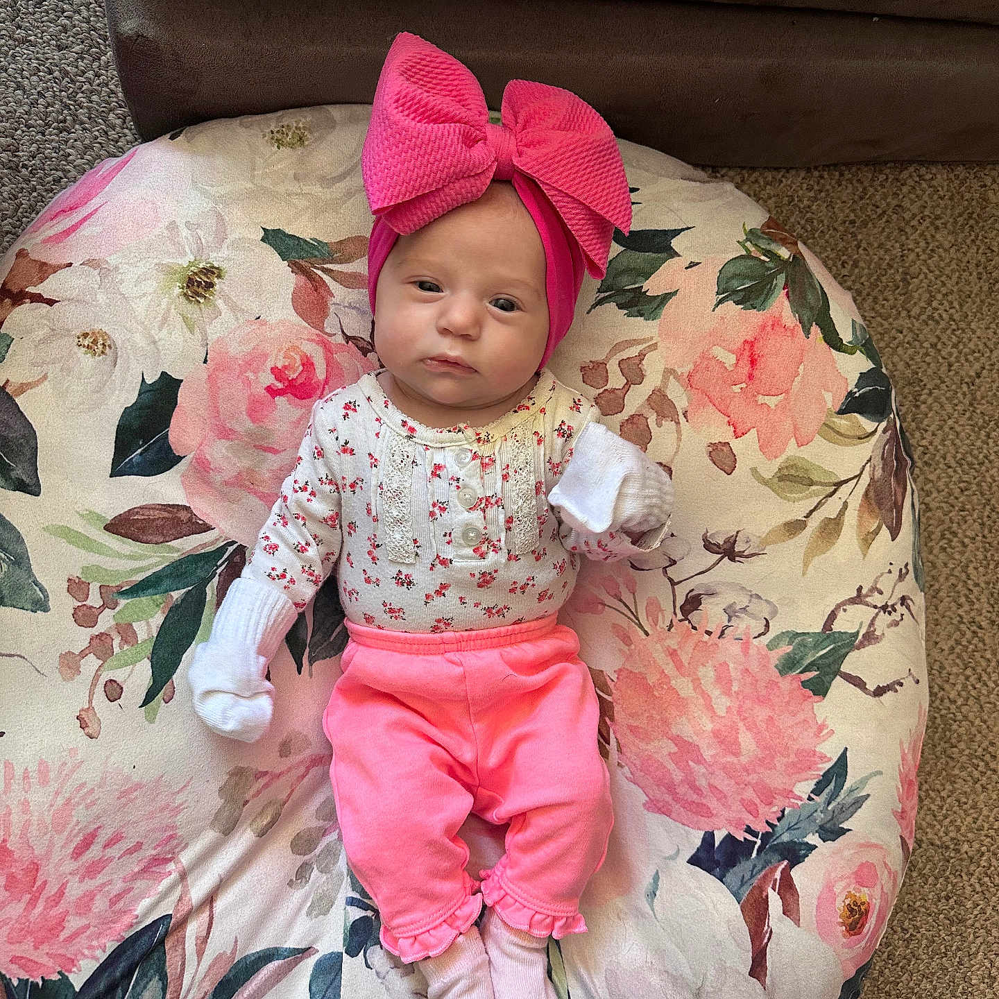 Braylee Mae is registered to the contest to win money with this photo: baby, baby_girl, carpet, casual_clothing, child, cozy, cute, fashion, floral_cushion, headband, indoors, infant, pink_bow, pink_pants, portrait, resting, small_person, sofa, white_mittens, white_socks