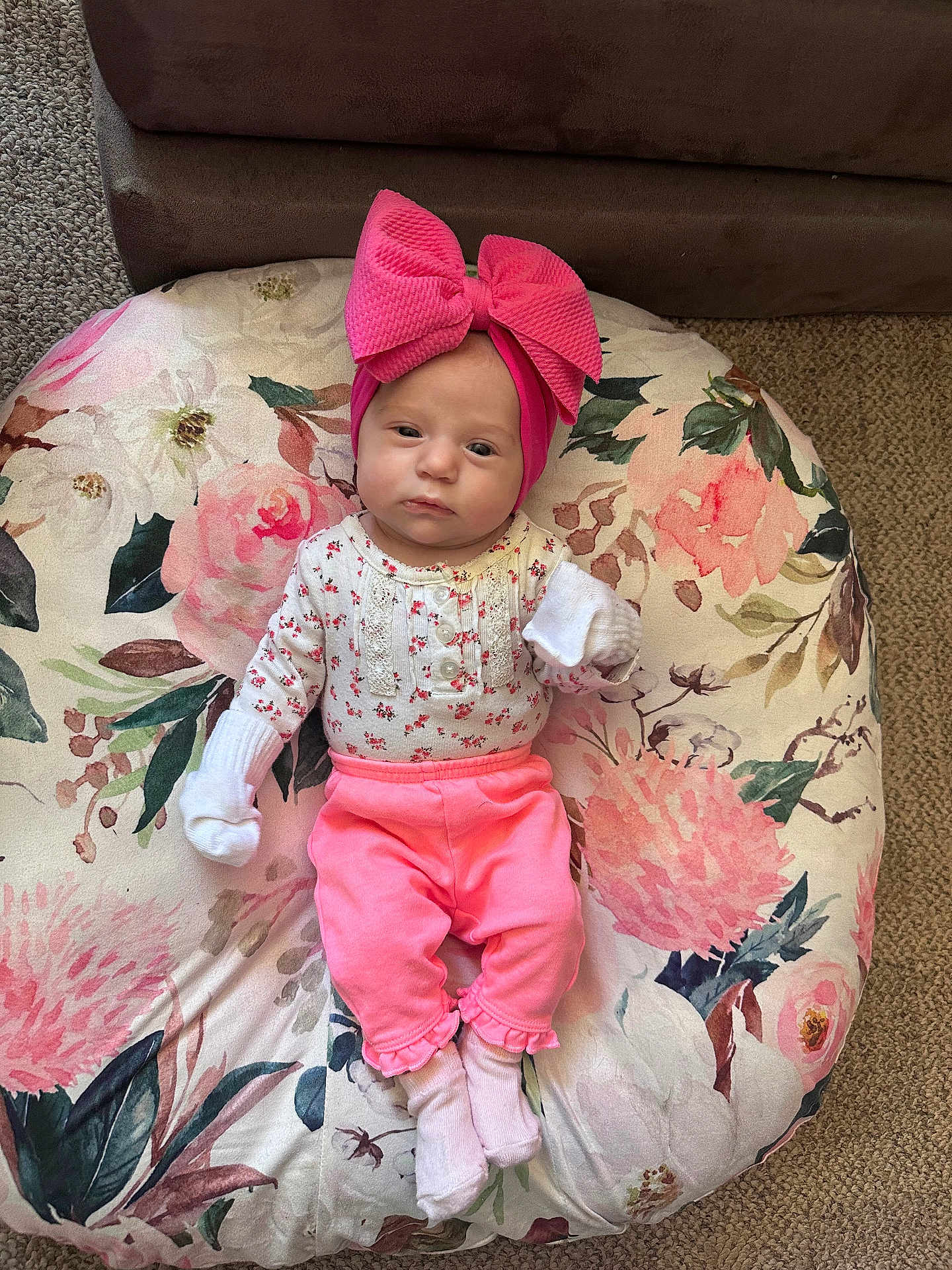 Braylee Mae is registered to the contest to win money with this photo: baby, infant, pink_bow, headband, pink_pants, white_socks, white_mittens, floral_cushion, carpet, sofa, indoors, portrait, child, cute, resting, fashion, small_person, cozy, casual_clothing, baby_girl