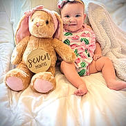 Sendaya is registered to the contest to win money with this photo: baby, child, plush_toy, bunny, bed, blanket, headband, pink, watermelon_print, smile, cute, infant, soft_toy, comfort, cozy, indoors, portrait, sitting, happy, person