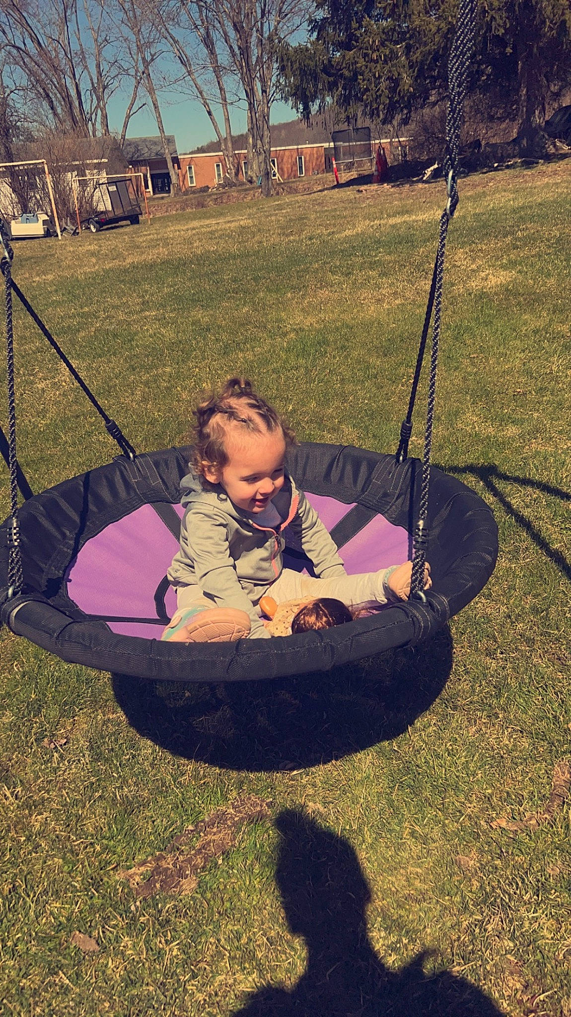 Karlee is registered to the contest to win money with this photo: circle, comfort, cool, eyewear, fun, grass, grassland, hammock, happy, joy, landscape, lawn, leisure, people_in_nature, person, plant, recreation, shade, sitting, swing