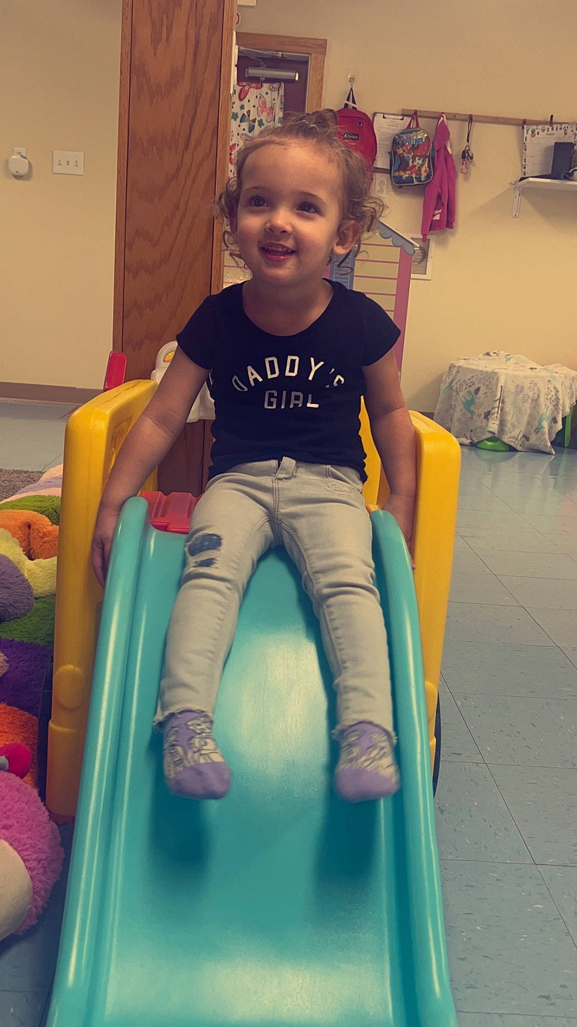 Karlee is registered to the contest to win money with this photo: baby, baby_toddler_clothing, child, comfort, electric_blue, flooring, fun, happy, human_leg, joy, knee, leg, leisure, person, playground, recreation, sleeve, smile, snapshot, t_shirt