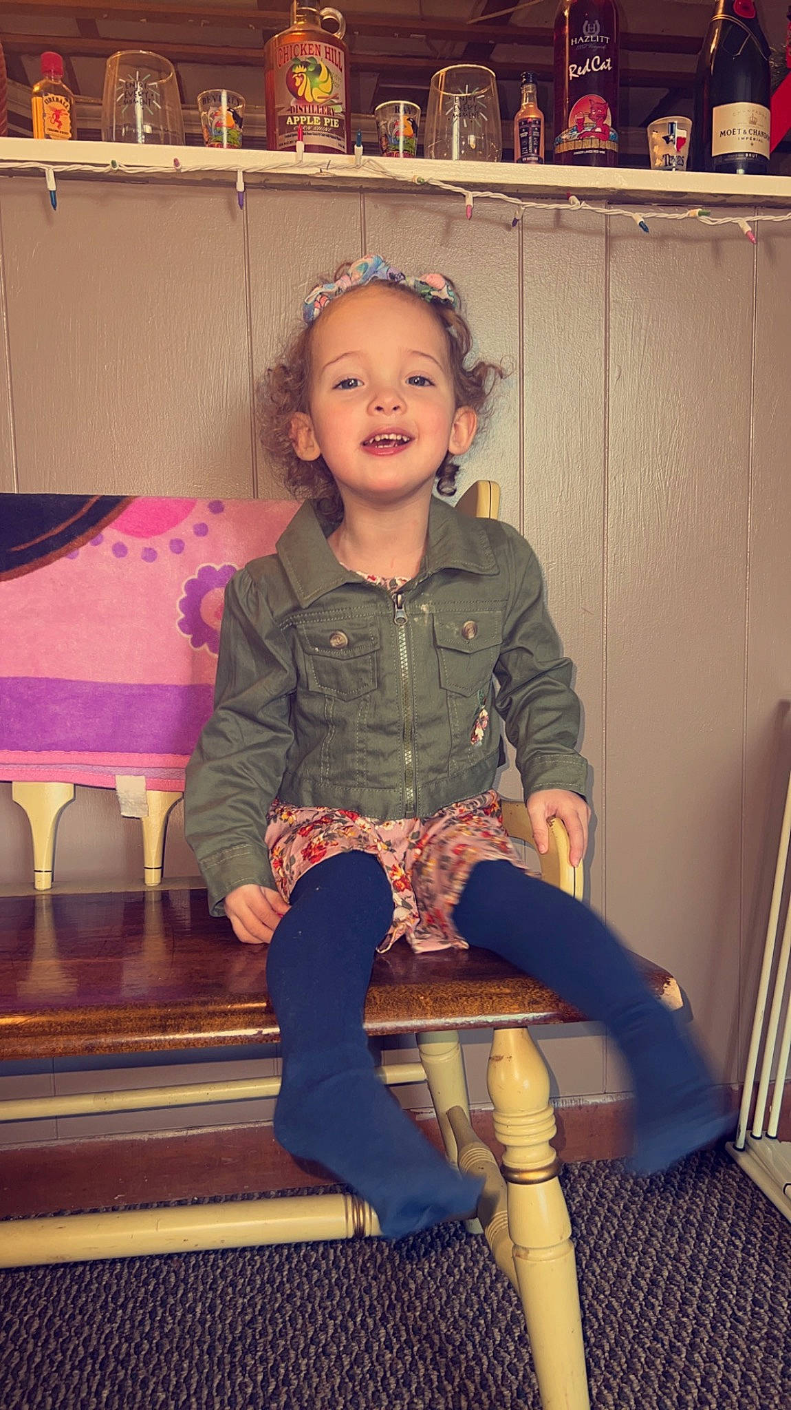 Karlee is registered to the contest to win money with this photo: blond, brown_hair, chair, event, face, fashion_accessory, fashion_design, flooring, fun, happy, human_leg, knee, leg, magenta, person, pink, sitting, sleeve, smile, thigh