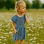child, girl, blue_dress, flowers, meadow, grass, outdoor, nature, summer, field, daisies, standing, blonde_hair, casual_clothing, sandals, portrait, curious, sunlight, greenery, peaceful