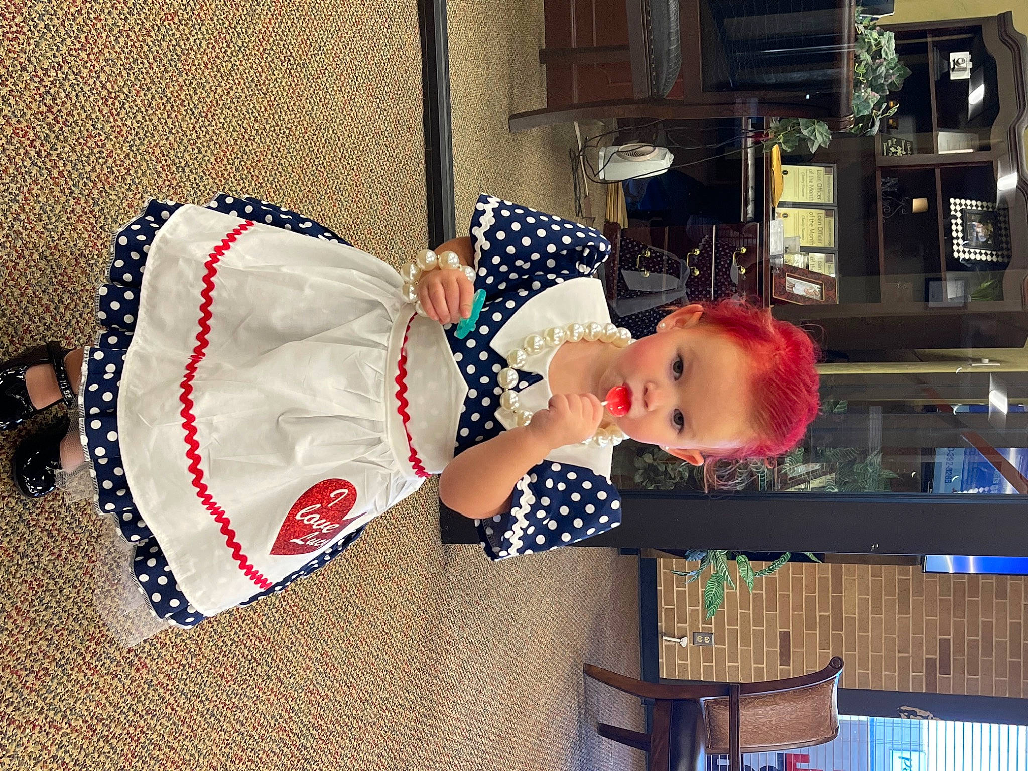 Skylyn is registered to the contest to win money with this photo: baby, baby_toddler_clothing, building, carmine, child, christmas_eve, costume_hat, event, flag_of_the_united_states, hat, holiday, linens, pattern, person, room, shelf, sleeve, toddler, window, wood